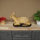 Stuffed fawn lying on a black base; older fawn; height 30...